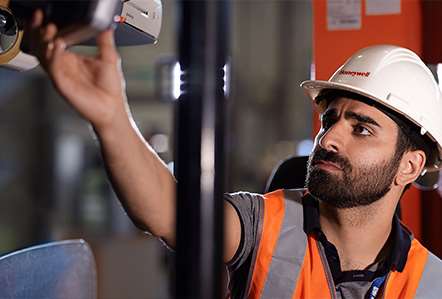 Warehouse worker using a mobile computer on the floor of a distribution center