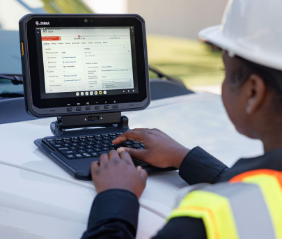 Logistics worker using a vehicle-mounted Zebra tablet for real-time shipment updates