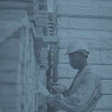 Warehouse worker scanning inventory with a handheld barcode scanner