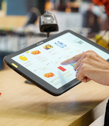 Rectangle-3.png Close-up of customer using Zebra touchscreen tablet to order food in QSR