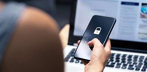 Hand holding a smartphone with a mobile security lock icon representing security technology solutions
