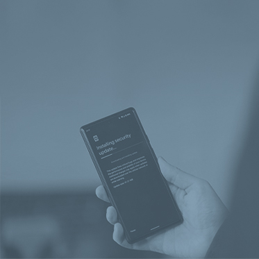 Hand holding a mobile device installing a security update