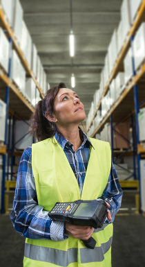 Warehouse employee using a rugged handheld scanner to manage inventory