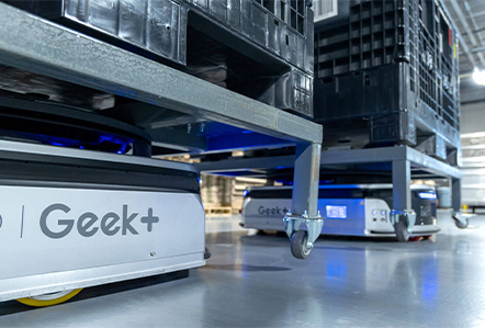 Autonomous mobile robots moving material inside a production and warehouse facility
